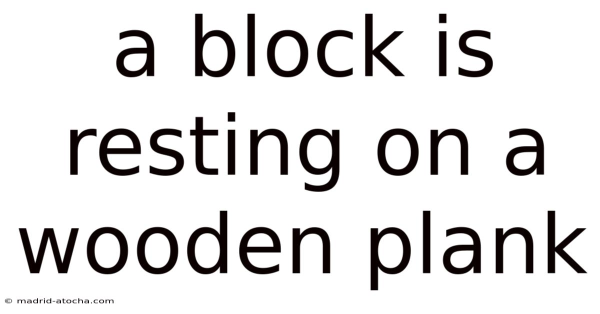 A Block Is Resting On A Wooden Plank